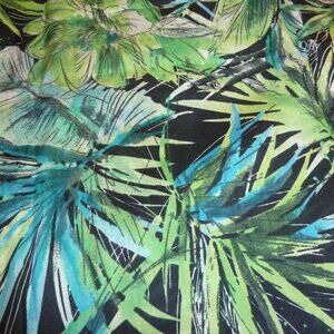 Fabric with a floral pattern transitioning from greens to blues